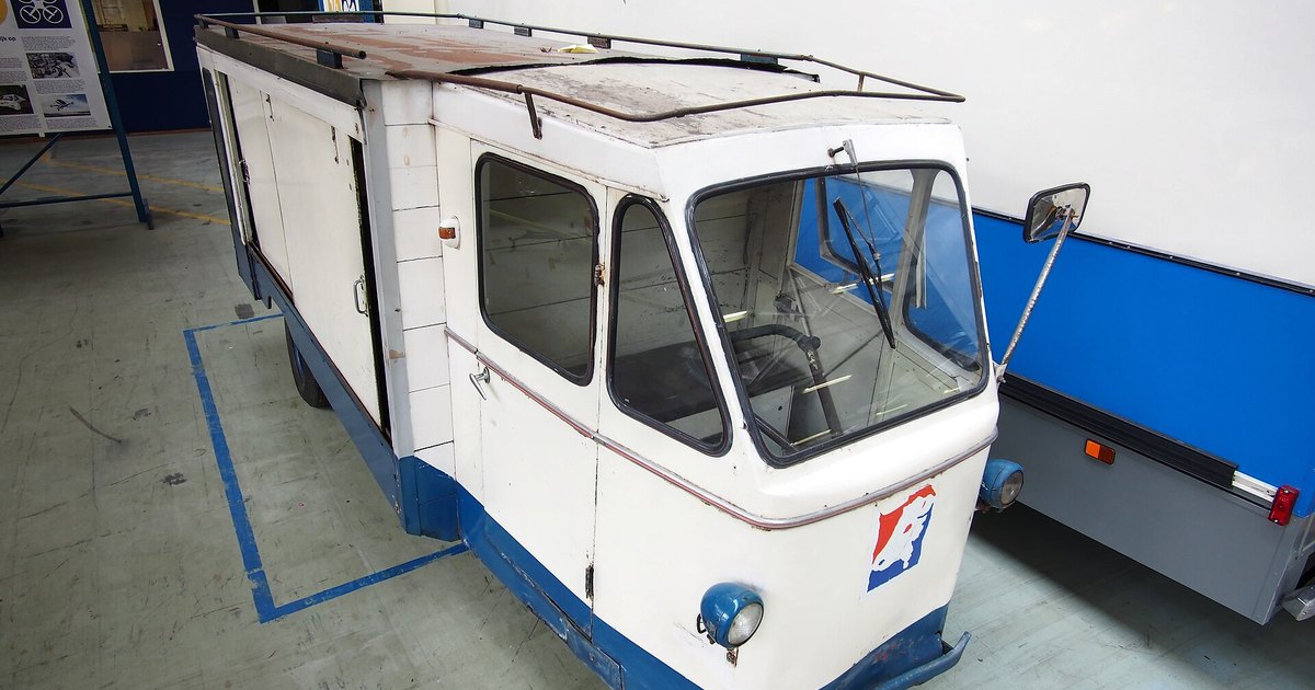A retired electric milk float parked in a museum hall